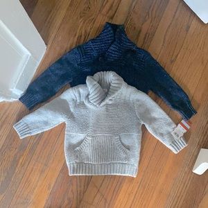 2 sweaters with tags on them and awesome shoes!